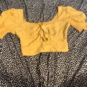 This shirt is a yellowish goldish color and it is good for partying.